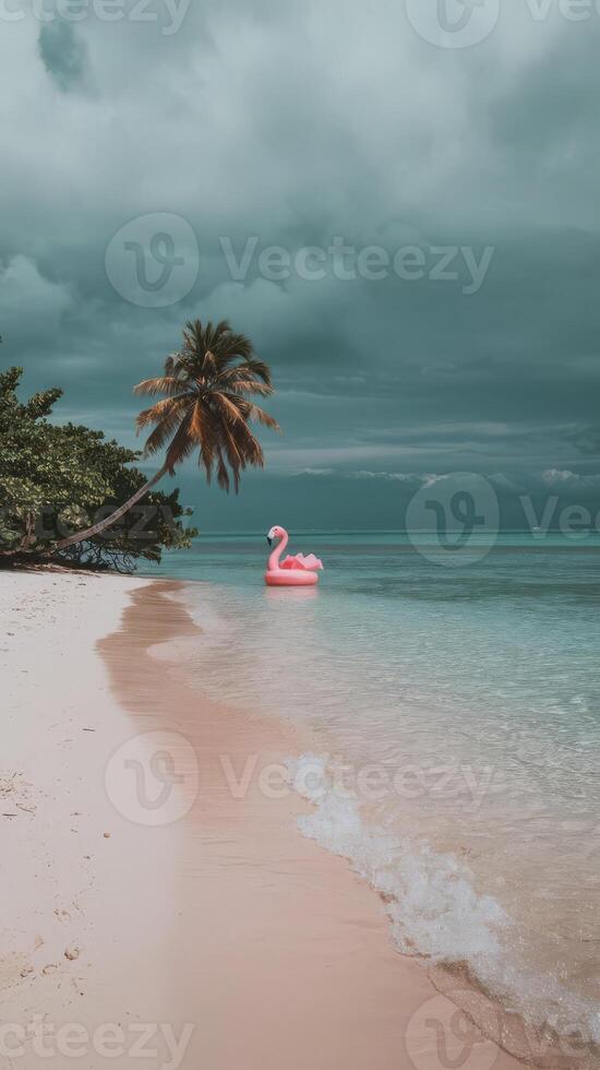 A pink flamingo floats on the beach in front of palm trees photo