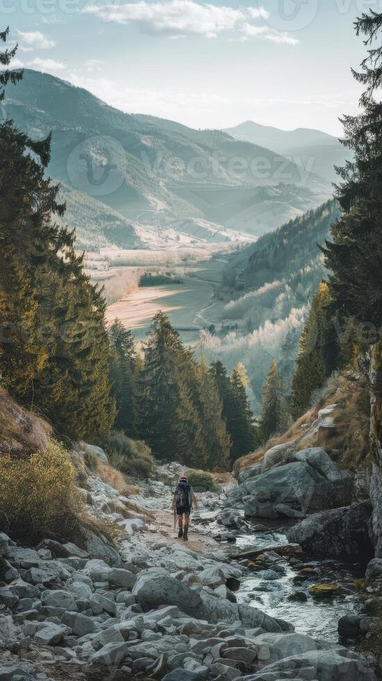 A man hiking on a rocky trail in the mountains photo