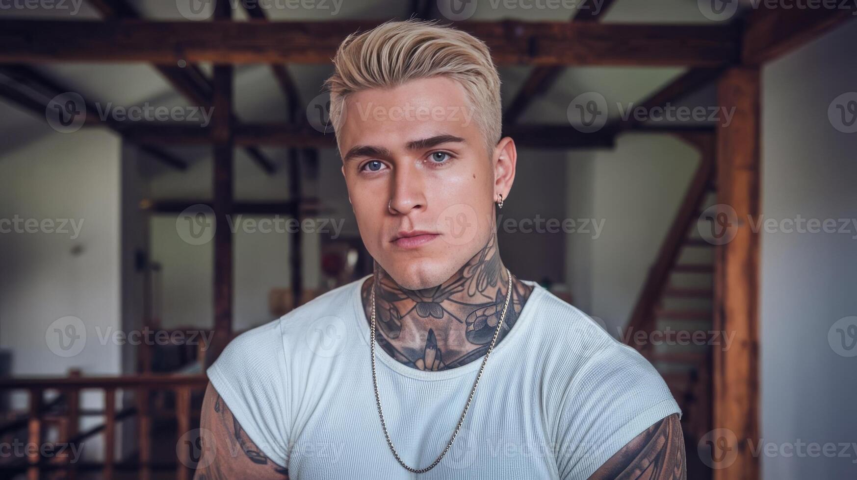 A man with tattoos and a white shirt photo