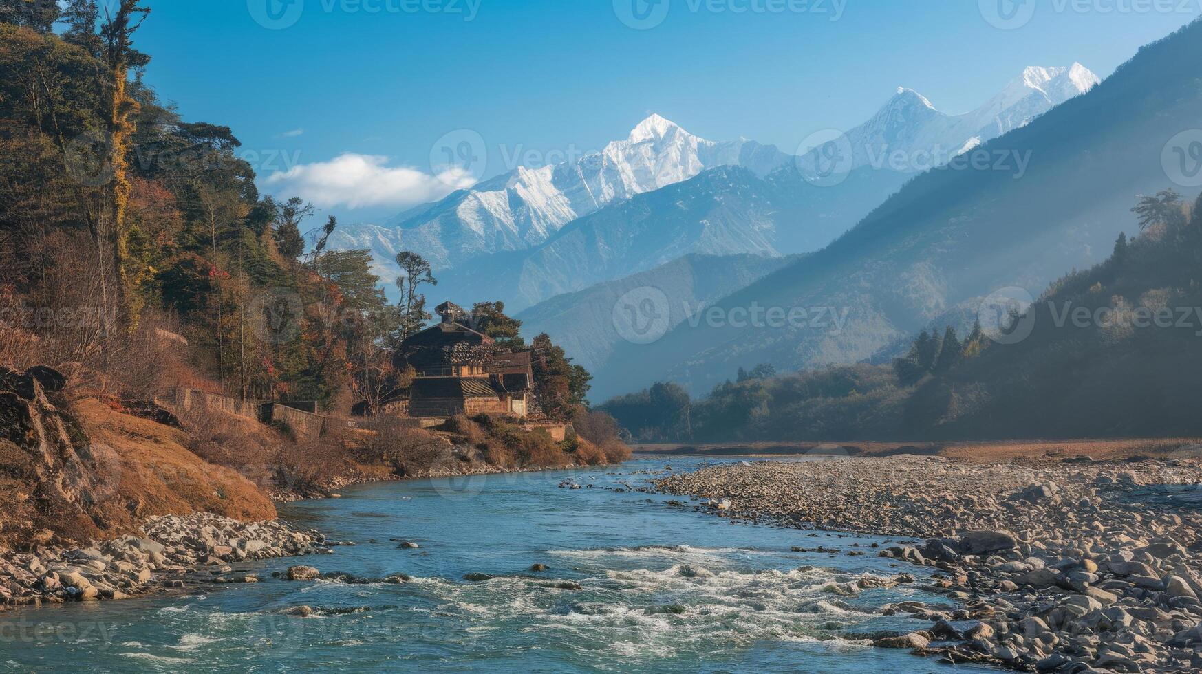 A river runs through a valley with mountains in the background photo