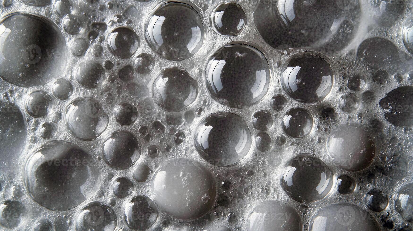 Close-up of soap bubbles with varied sizes and reflections in white background photo