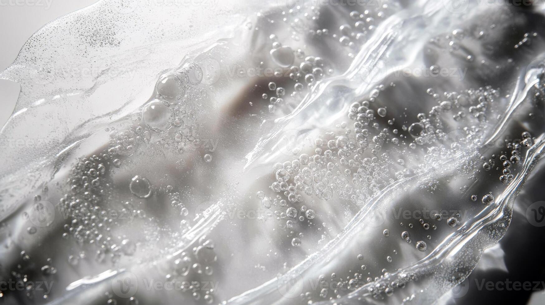 Close-up of transparent gel texture with bubbles and wavy patterns photo