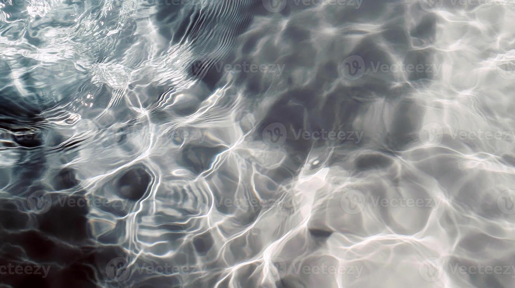 Turquoise pool water with sunlight reflections and ripple patterns photo