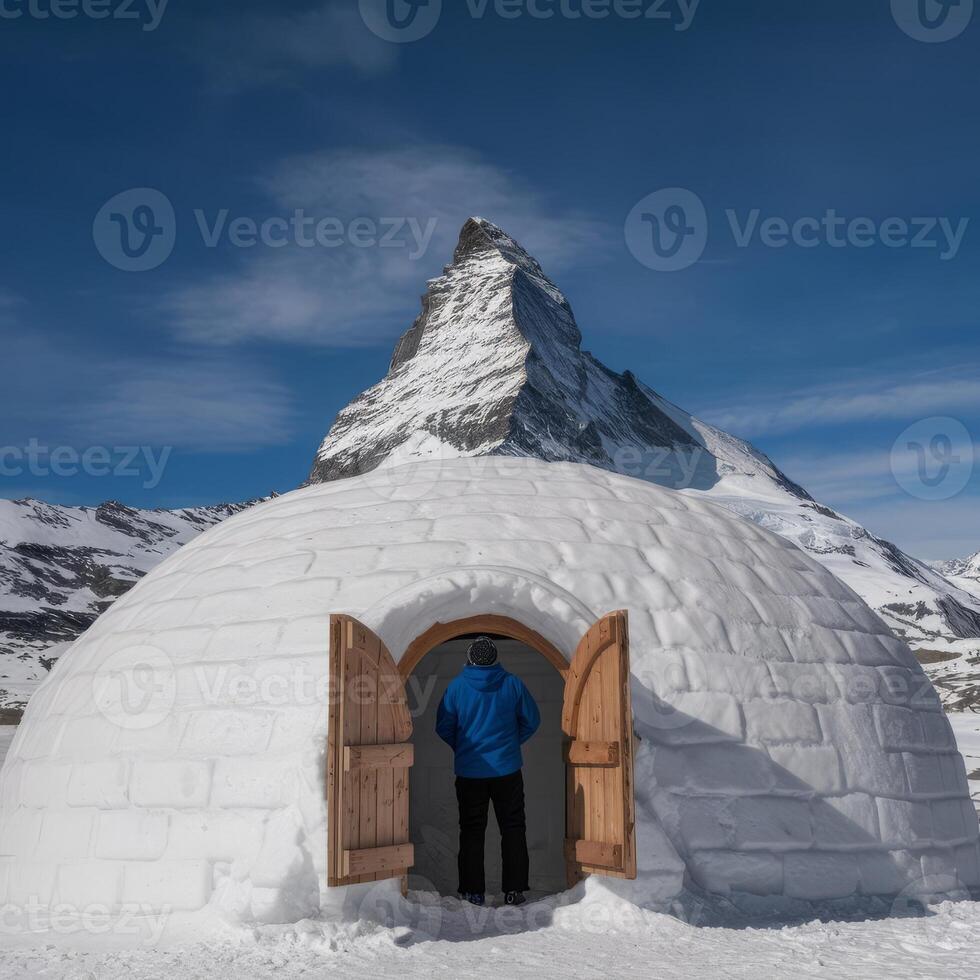 A man standing in front of an igloo photo