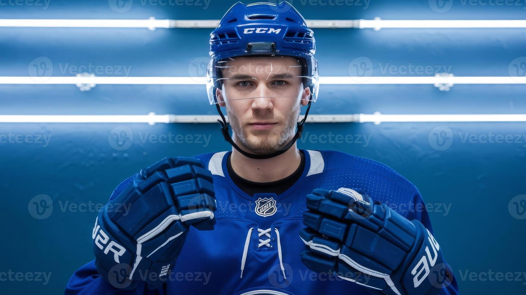 A hockey player in a blue uniform posing for a photo