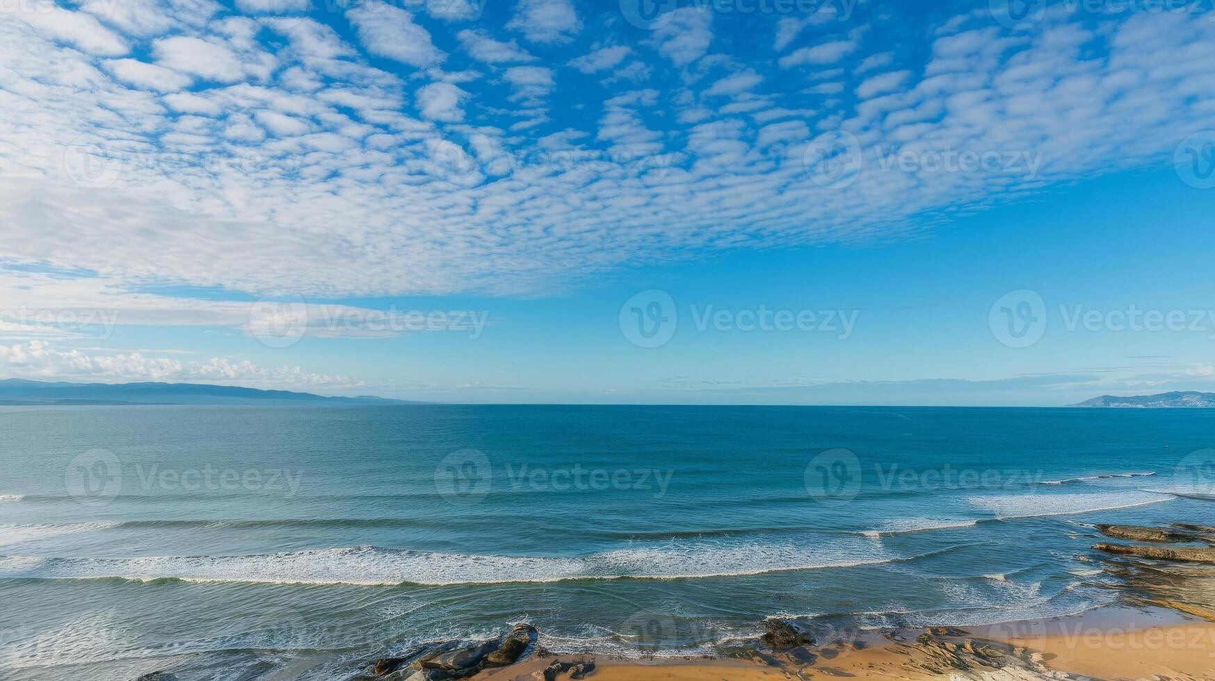 A view of the ocean and clouds from a cliff photo