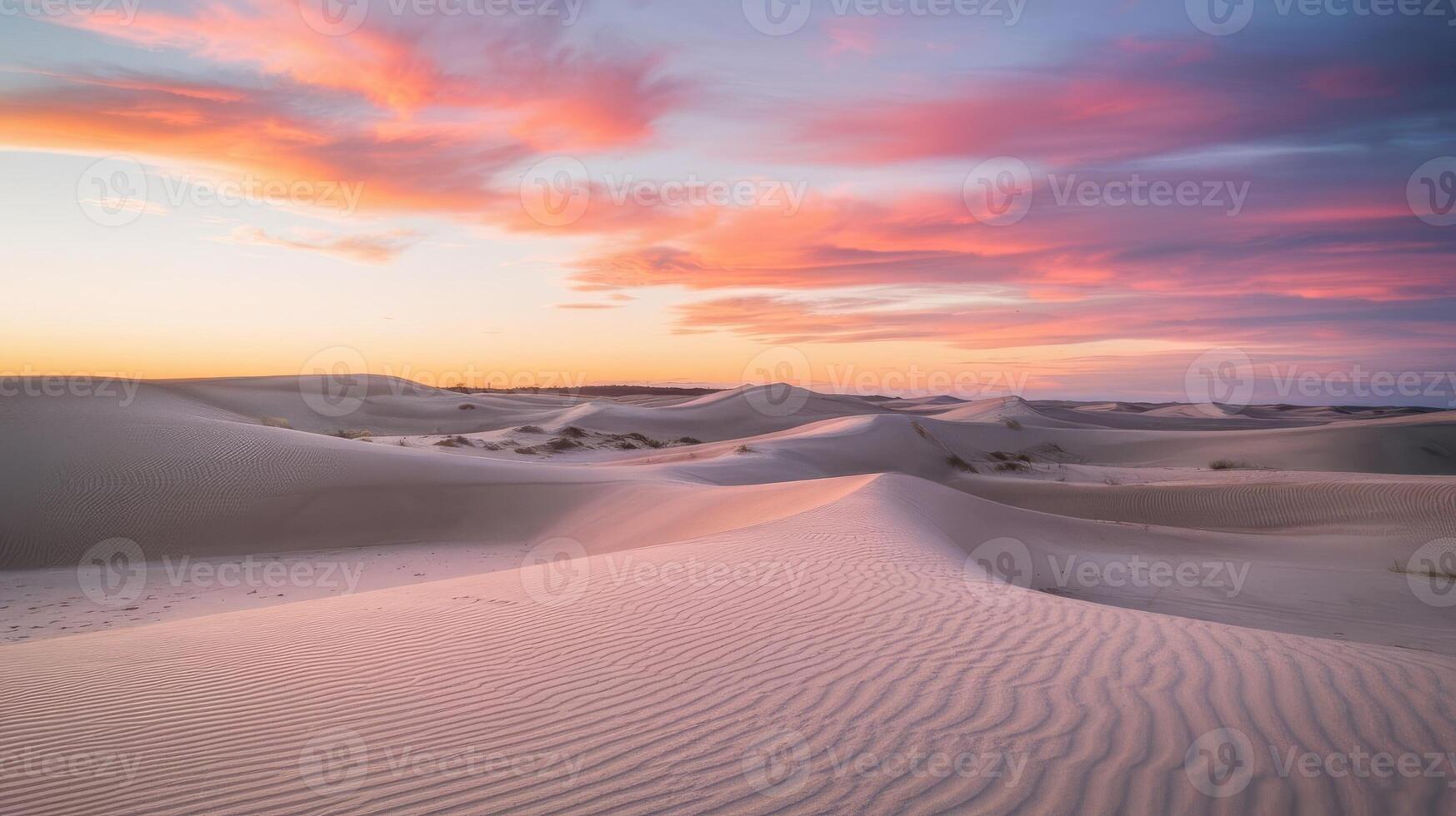 Sand dunes at sunset with clouds in the sky photo
