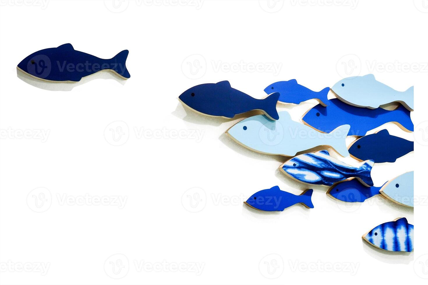 Abstract Composition of Blue Fish Shapes on White Background Illustrating Movement and Contrast in Minimalist Design photo