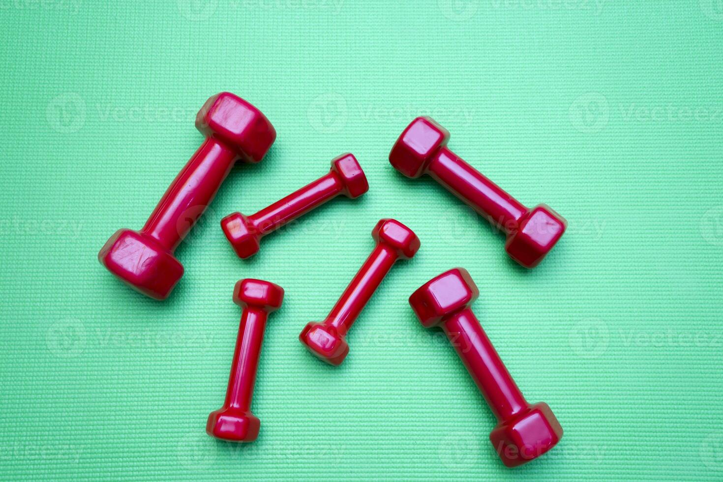 small dumbbells on green background photo