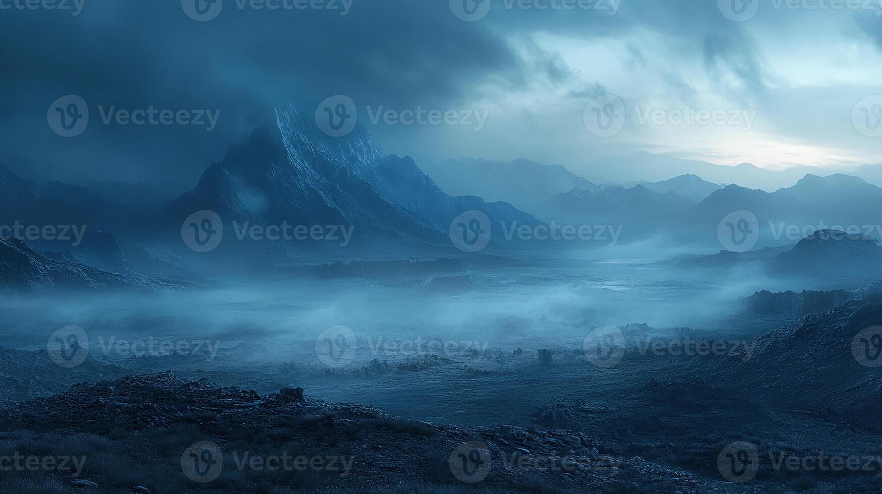 A dark blue landscape with mountains and fog photo