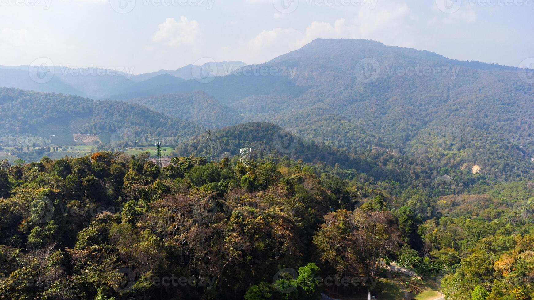 Scenic landscape showing forested hills and mountains stretching into the distance in Thailand under pollution with dust photo
