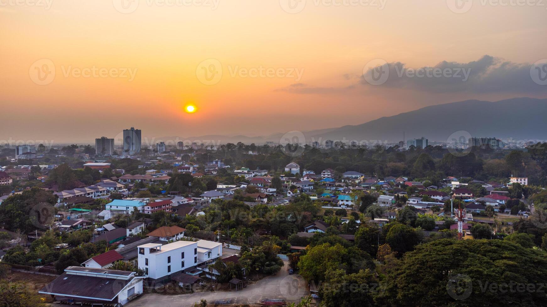 Chiang Mai urban landscape at sunset with Doi Suthep mountain in the background with pollution photo