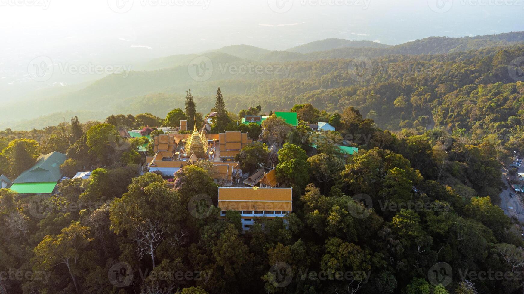 Wat Phra That Doi Suthep temple shining on mountain top in Chiang Mai in Thailand during sunrise photo