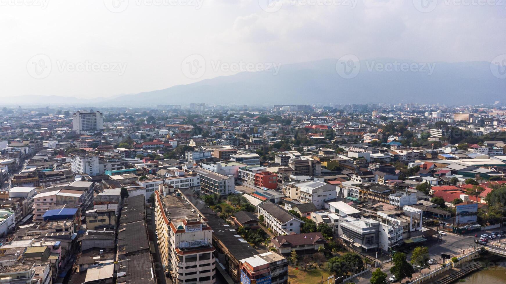 Chiang Mai cityscape expanding towards Doi Suthep mountain range under polluted sky photo