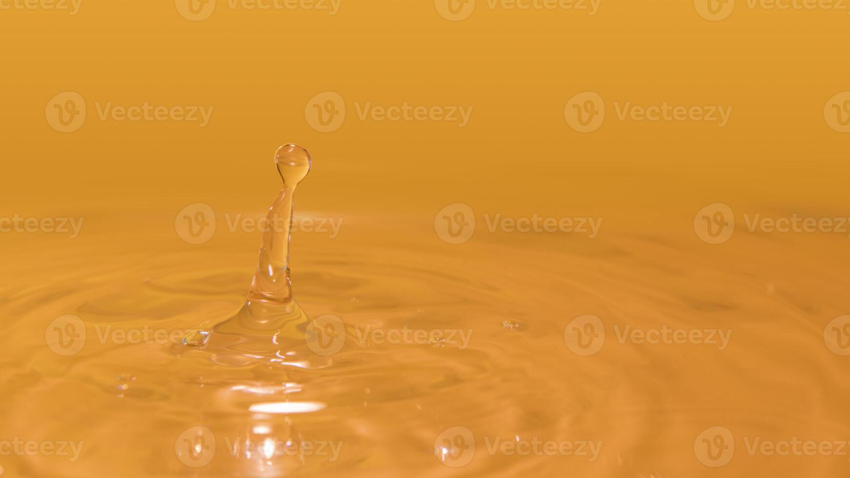Water drops splashing on the water surface forming waves illuminated with yellow light photo