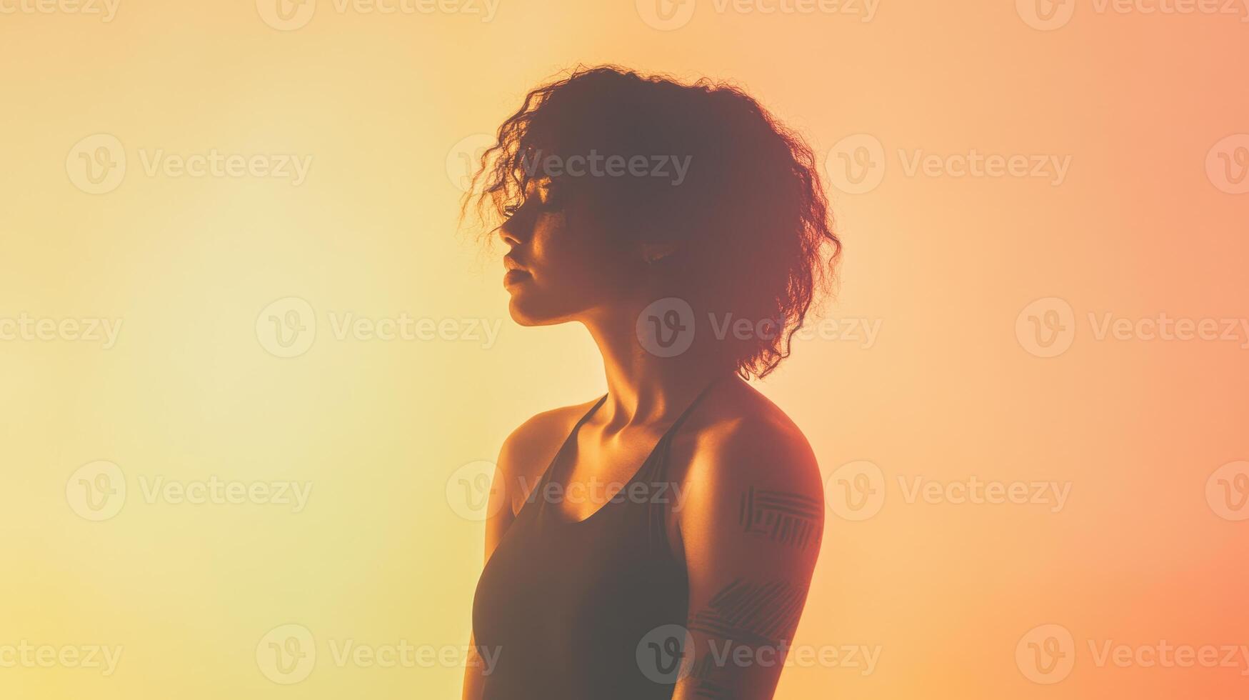 A silhouette of a person with curly hair against a colorful gradient background, evoking a sense of introspection and mood. photo