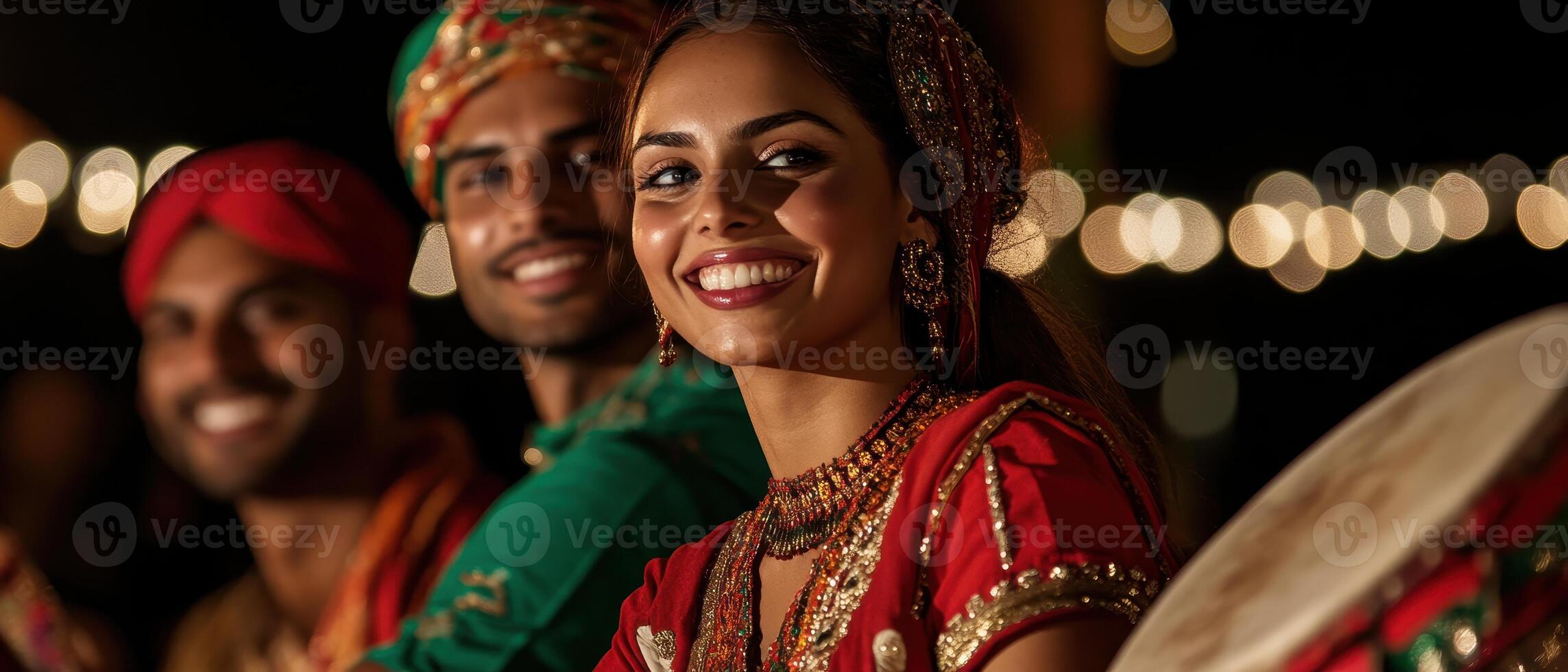 A vibrant celebration featuring smiling individuals in traditional attire, surrounded by festive lights, creating a joyful atmosphere. photo
