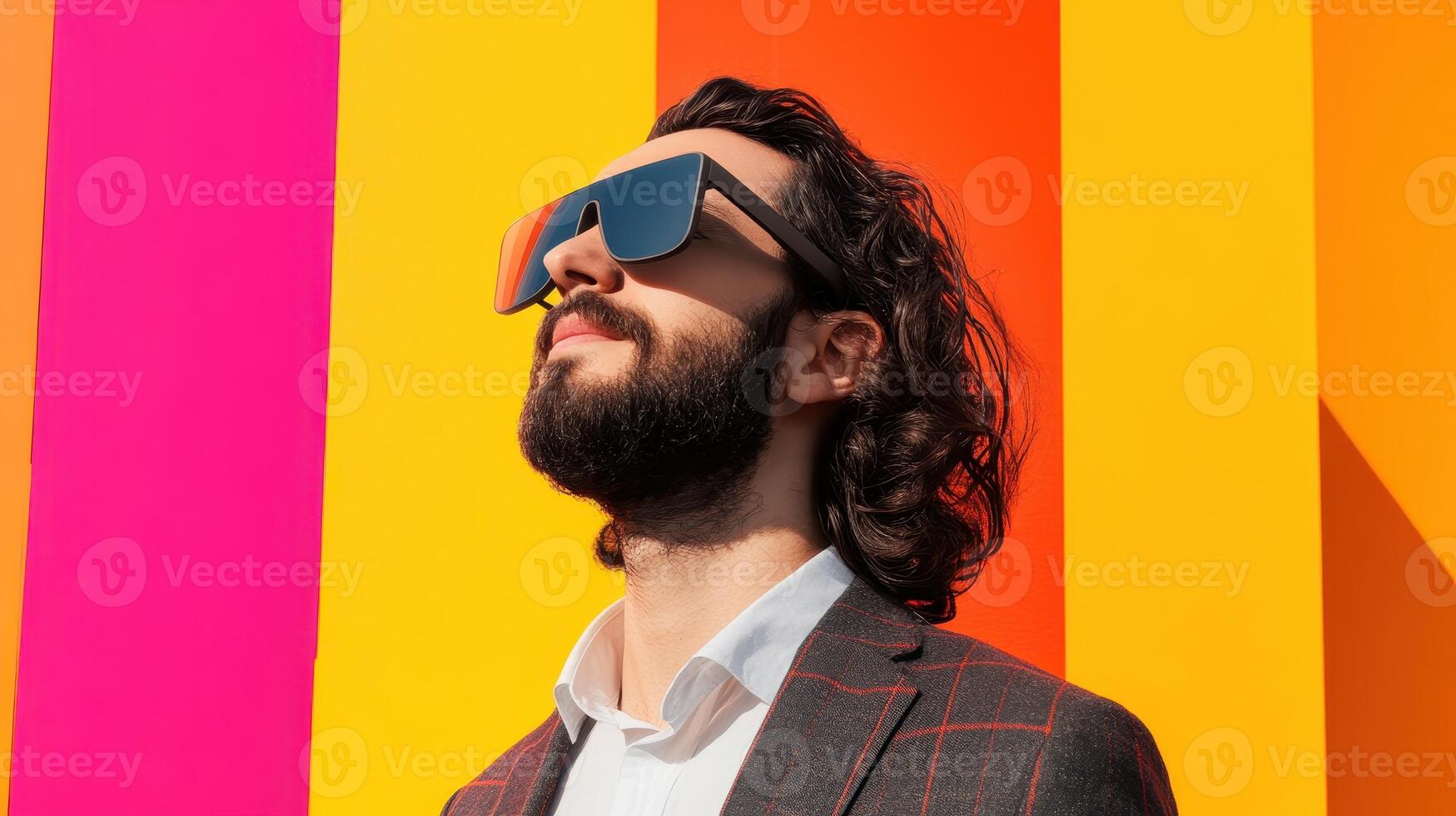 Digital Marketing Spend Concept. Man with sunglasses gazes upward against a vibrant, colorful background of pink and orange stripes. photo