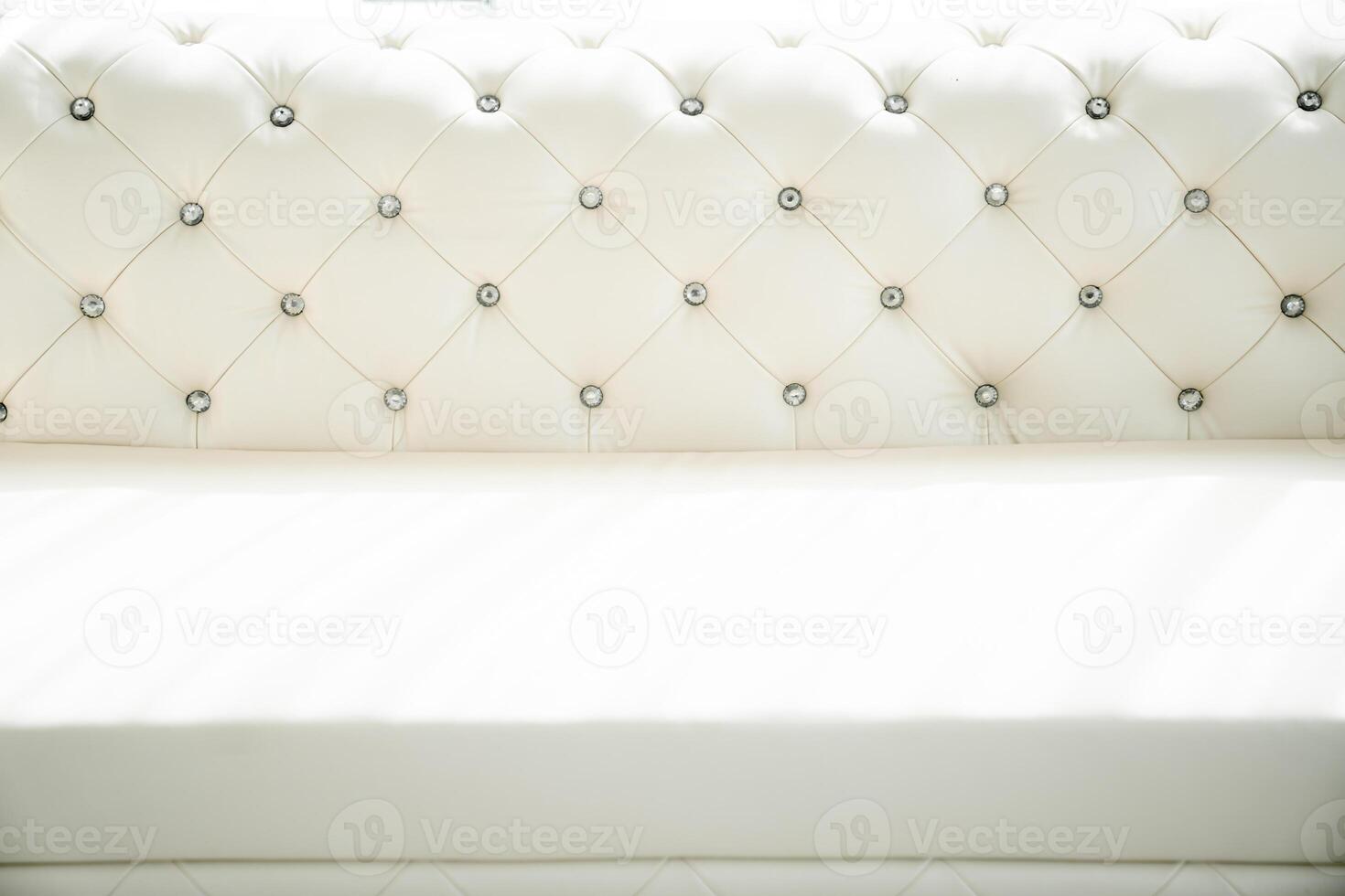 In a room that sparkles with mirrored walls and sun -drenched light, a sophisticated sofa set exudes elegance and style. photo