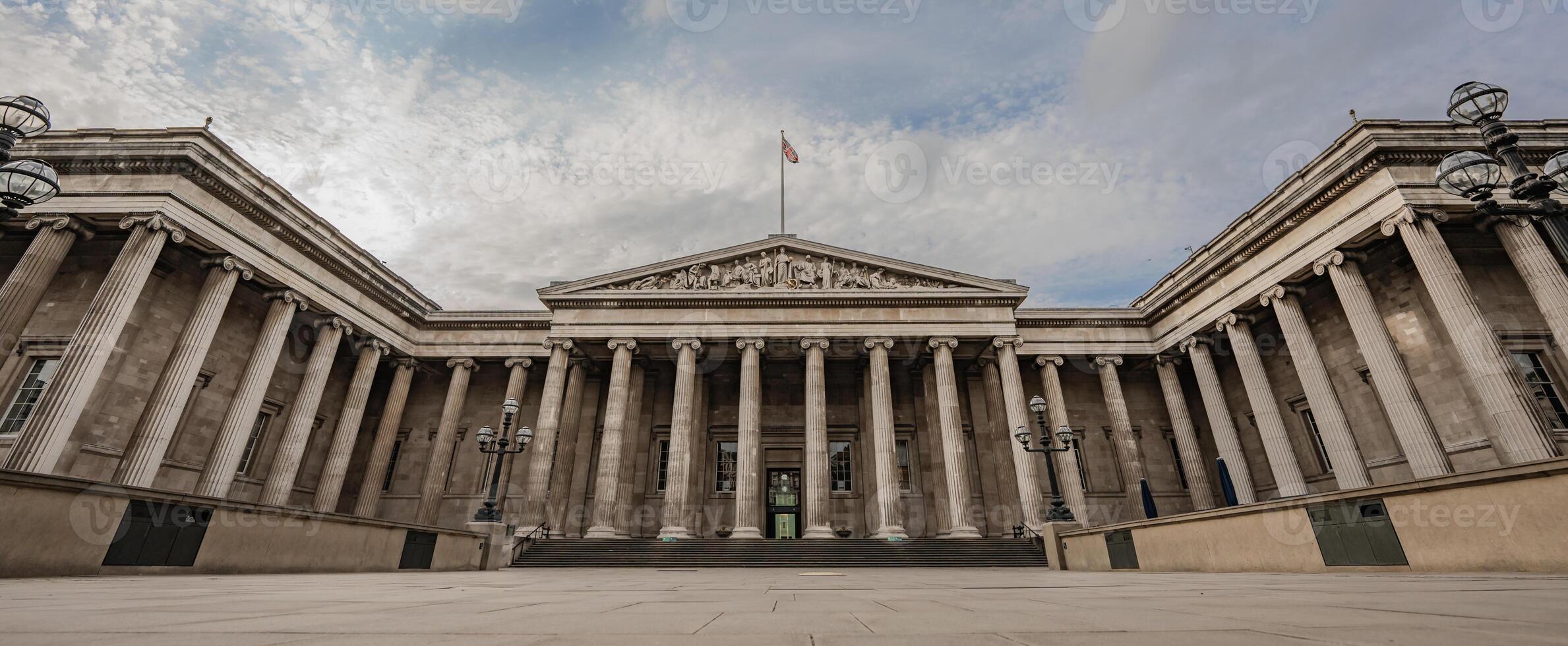 British Museum neoclassical facade stands tall with iconic columns and a balanced design, symbolizing its rich history. photo