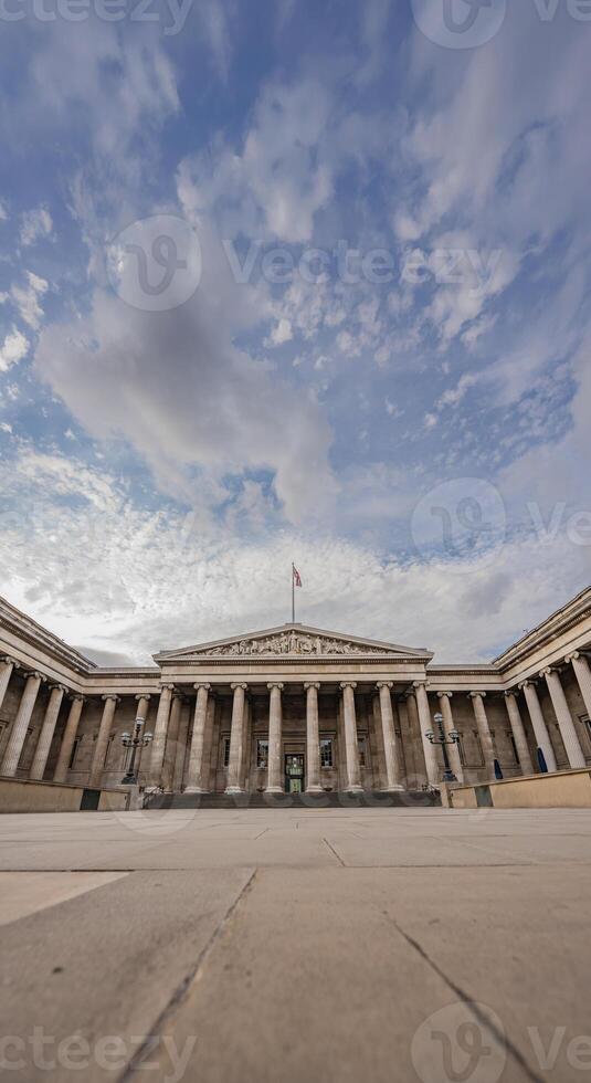 Neoclassical facade of the British Museum in London, with its symmetrical columns, emphasizes the museum historic legacy under an open sky. photo
