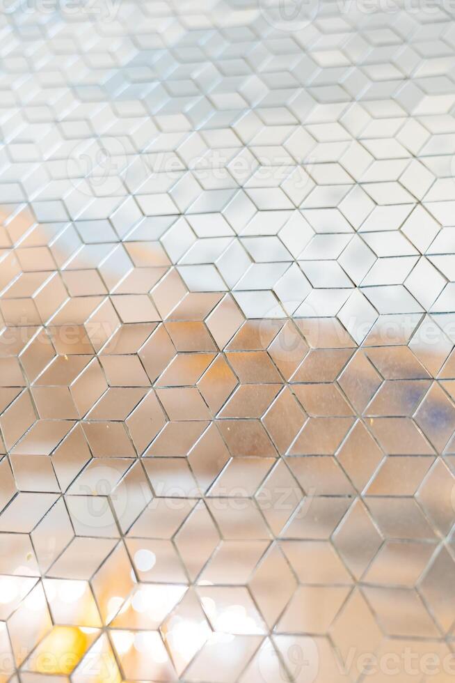 Shiny mirror cut in a cube shape for decorating w all and floor, laying mirror tile in 3d cube geometric pattern. photo