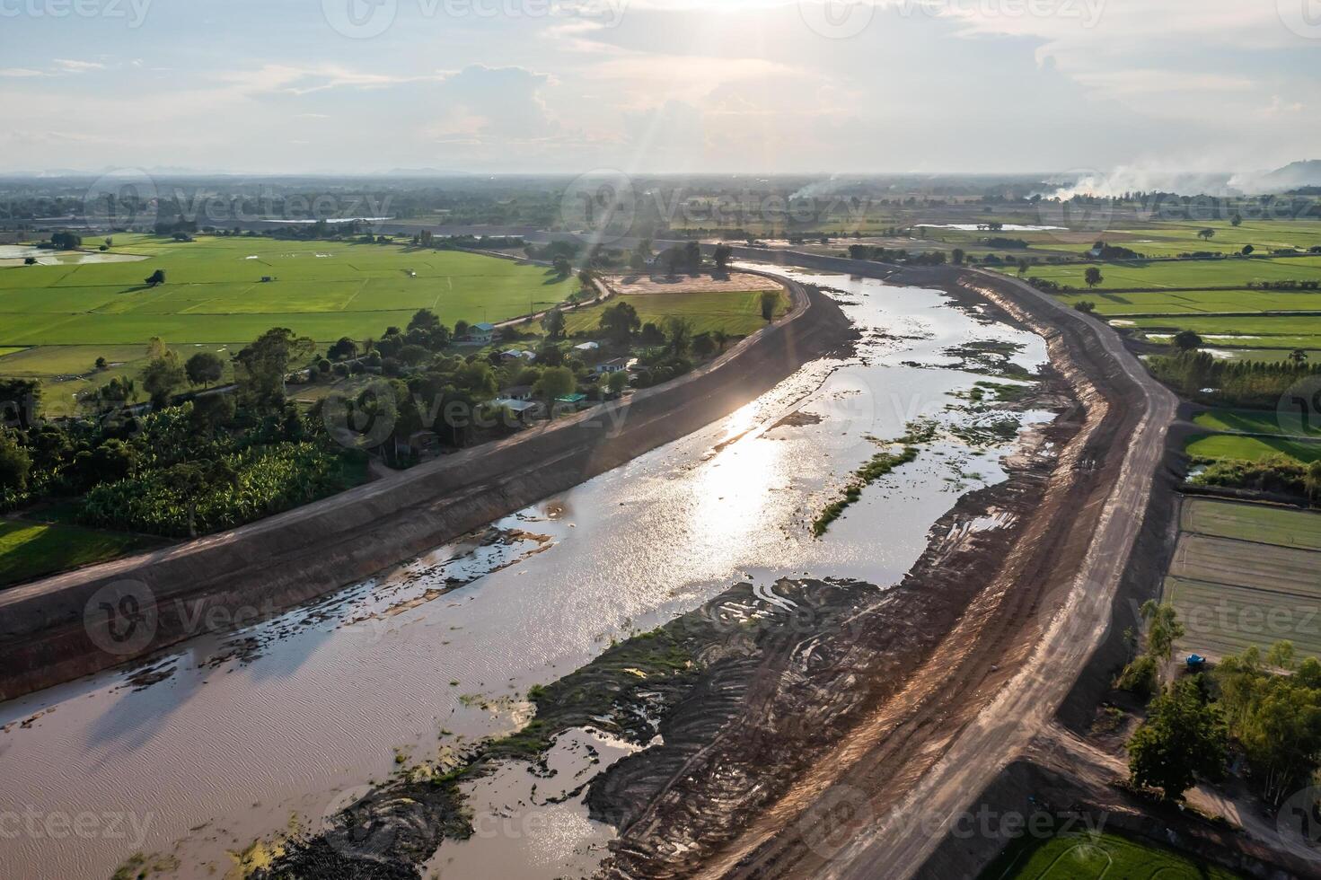 Construction dredges up for a canal and da m, to prevent a flood in the rainy season. Date on 14 May 2021 at Uthai Thani province, Thailand. photo
