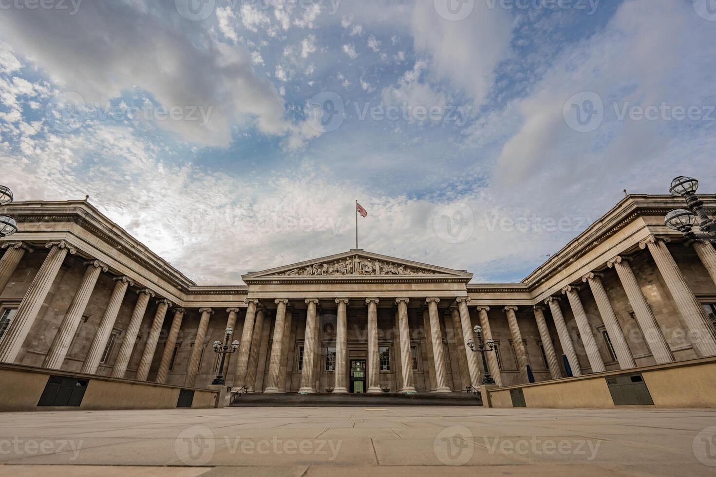 The British Museum impressive columns and symmetrical architecture showcase neoclassical design, highlighting its significance against the vast London sky. photo