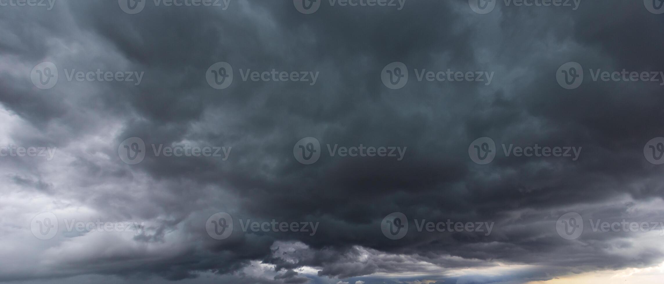 dark sky with heavy clouds converging and a violent storm before the rain.Bad or night weather sky and environment. carbon dioxide emissions, greenhouse effect, global warming, climate change photo