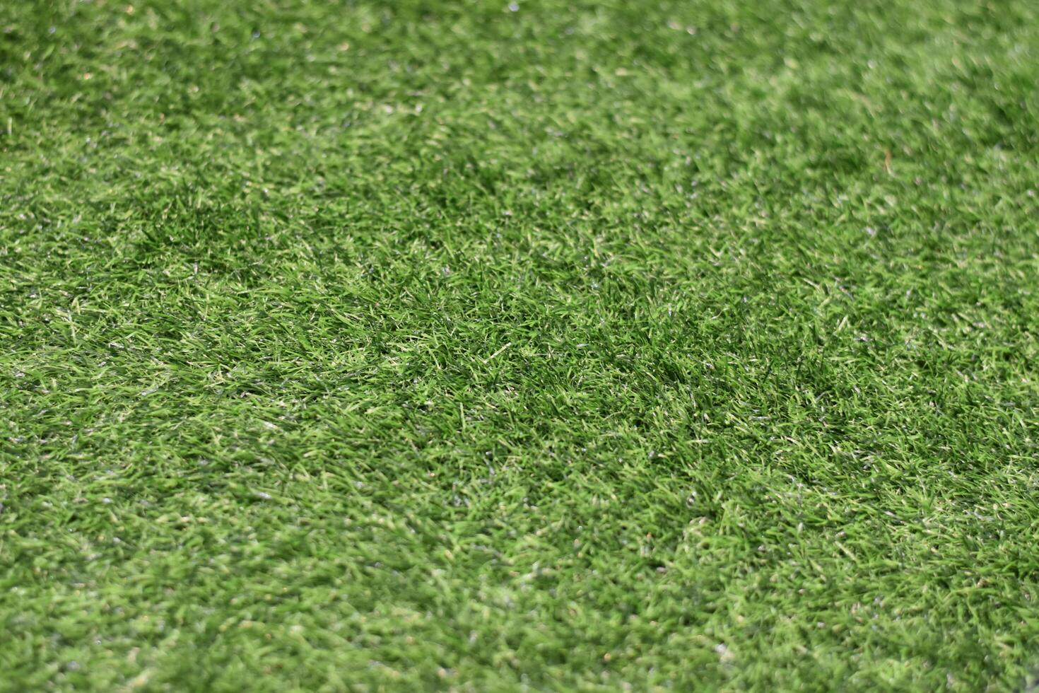 Plastic carpet with green grass and fiber photo