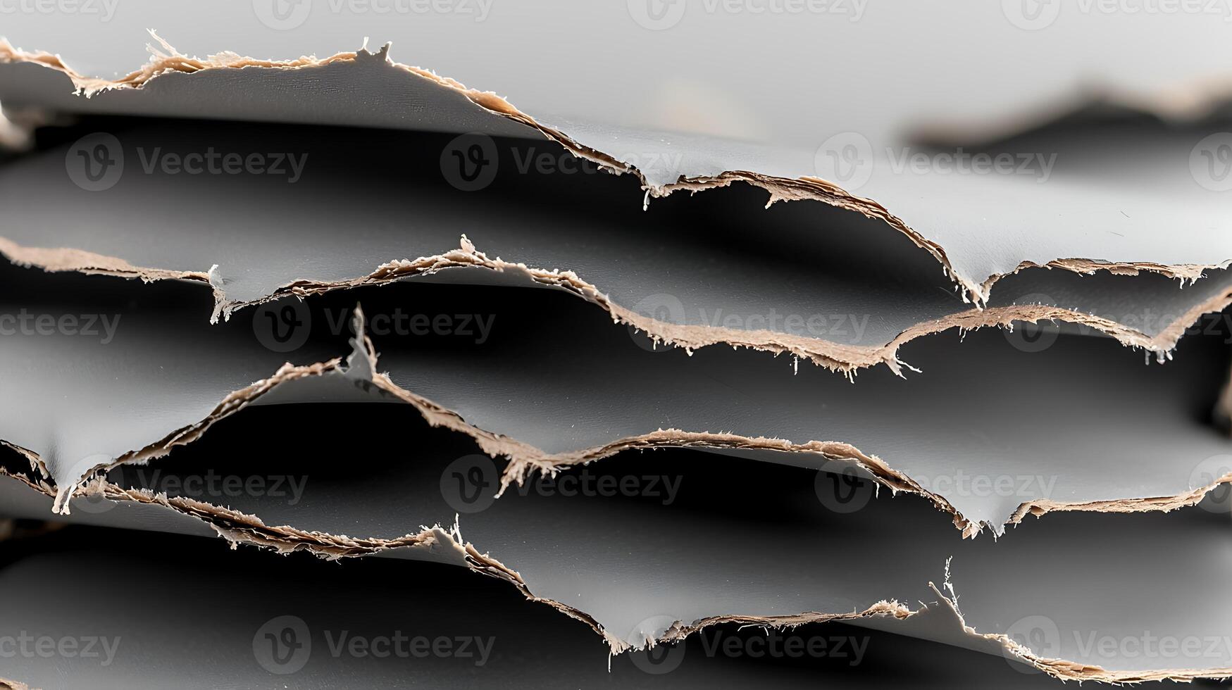 Close-up of torn paper layers revealing texture and depth, showcasing a minimalist aesthetic photo