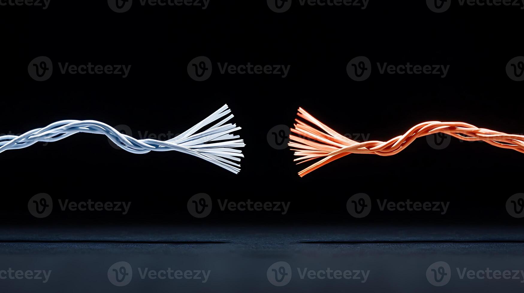 Close-up of twisted electrical wires in contrasting colors against a dark background photo