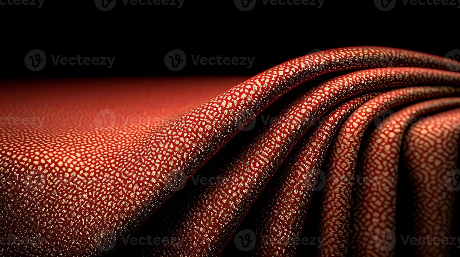 Close-up of textured red fabric with intricate patterns, softly draped against a dark background photo