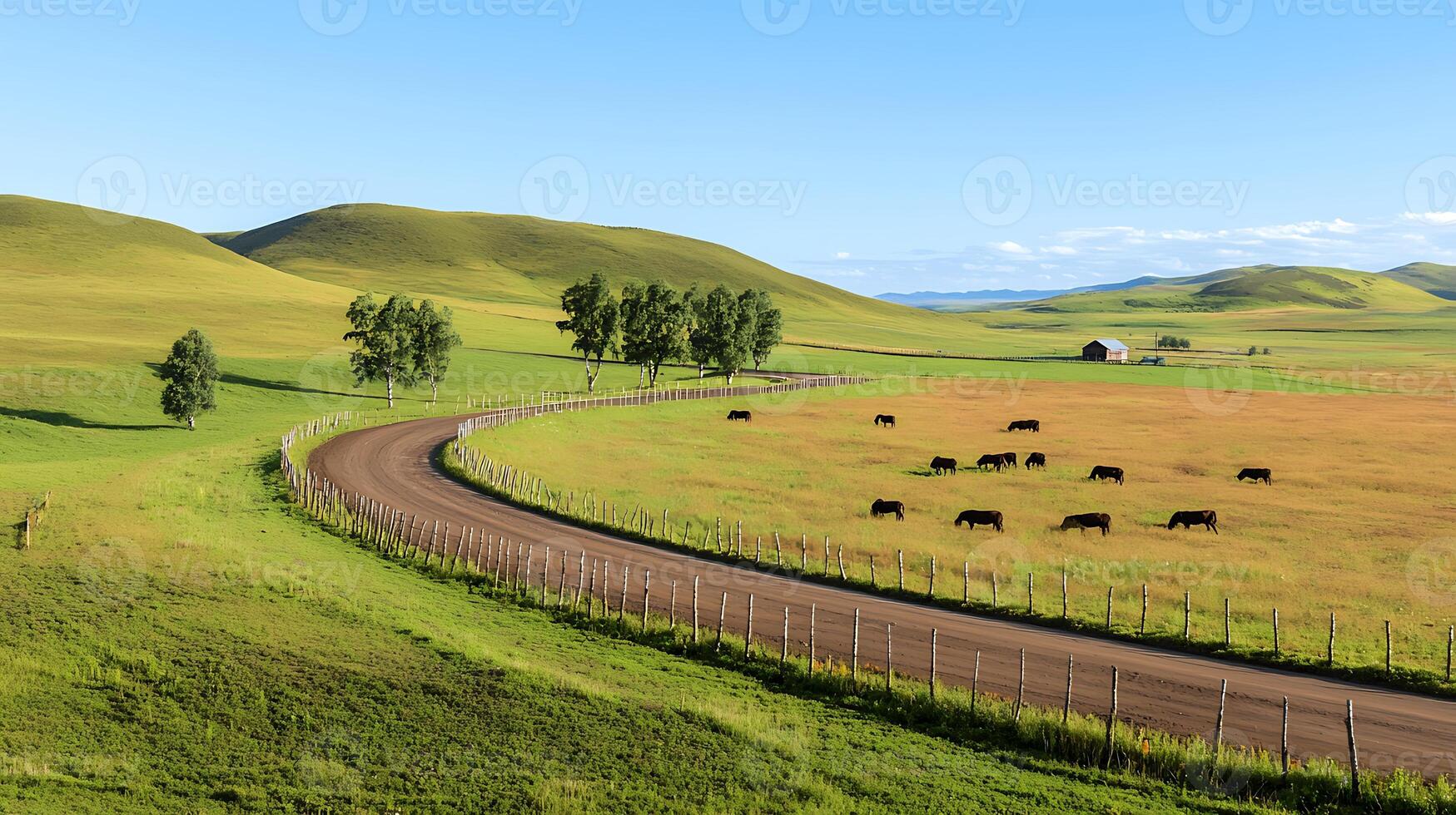 Serene countryside landscape with winding road, grazing cattle, and distant barn under blue sky photo