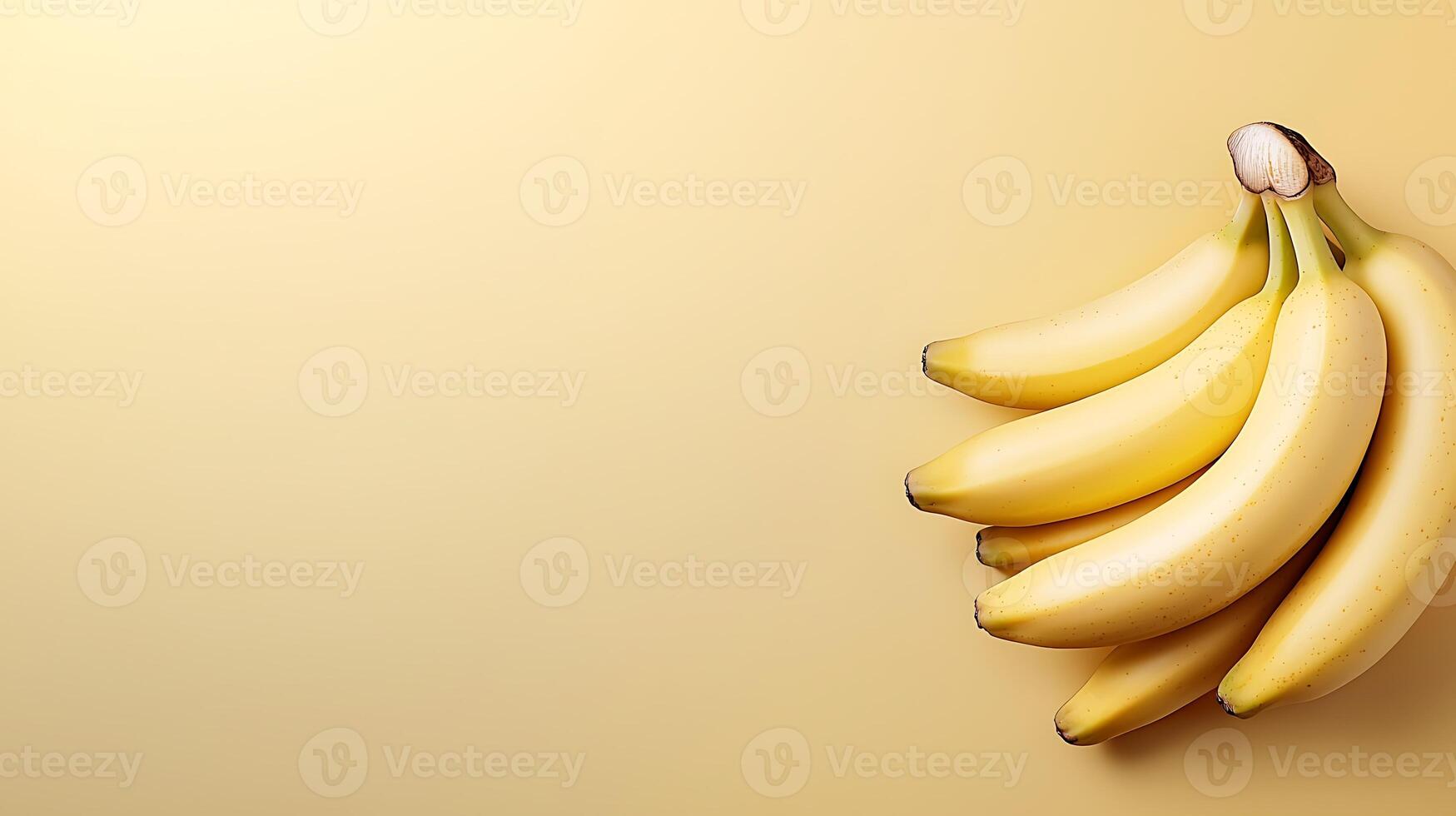 A cluster of ripe bananas resting on a soft yellow background, ideal for food-related content photo