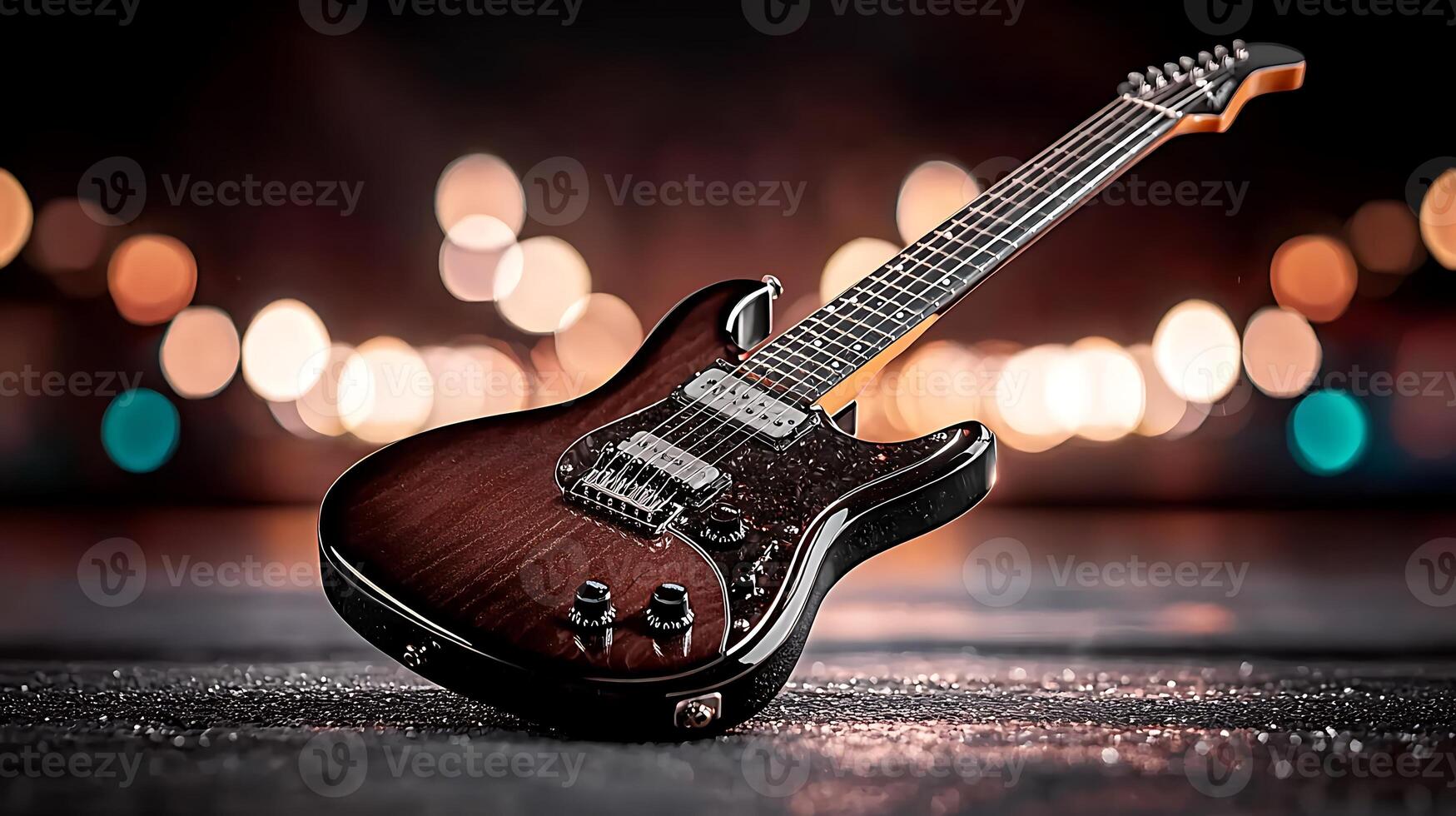 A beautifully crafted electric guitar resting on a reflective surface with blurred lights in the background photo