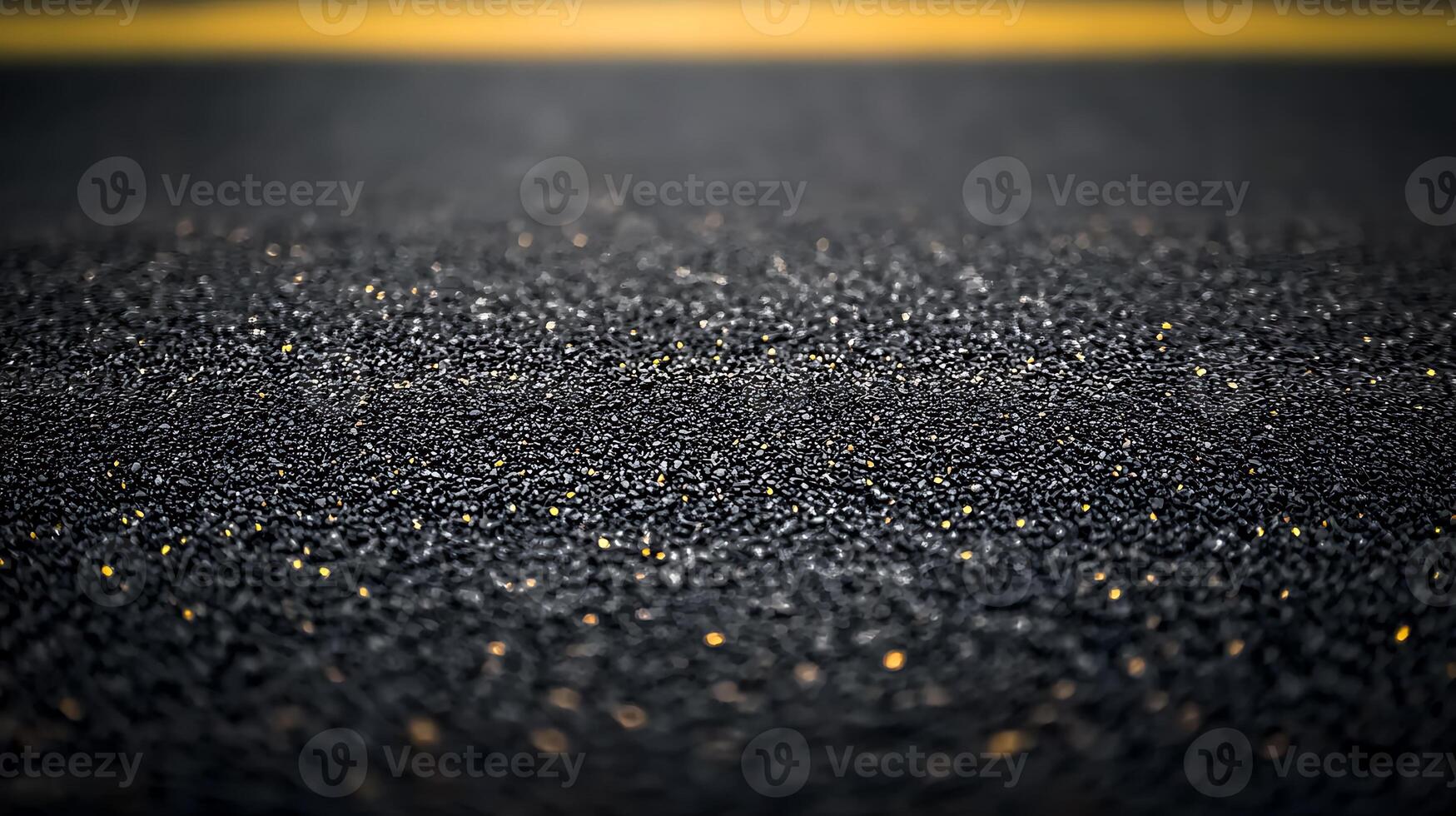 Close-up view of a textured asphalt surface with shimmering particles under warm sunlight photo