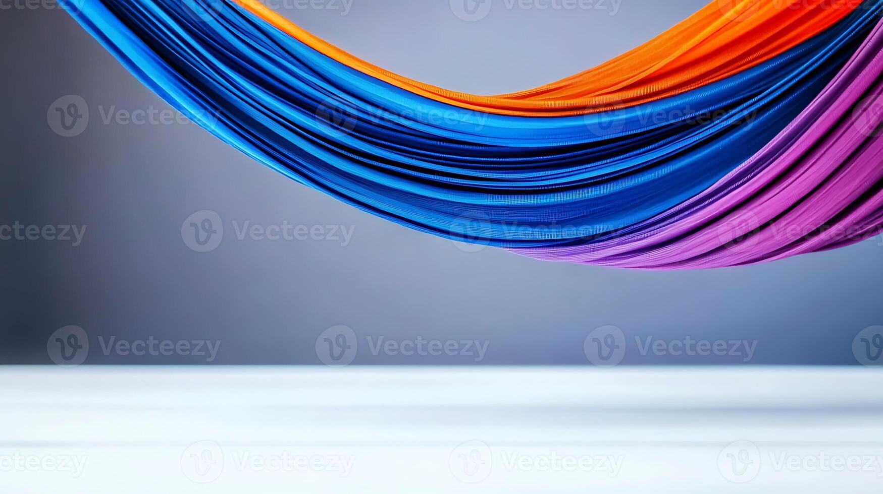 Vibrant colored fabric draped elegantly against a soft gray background, creating a serene atmosphere photo