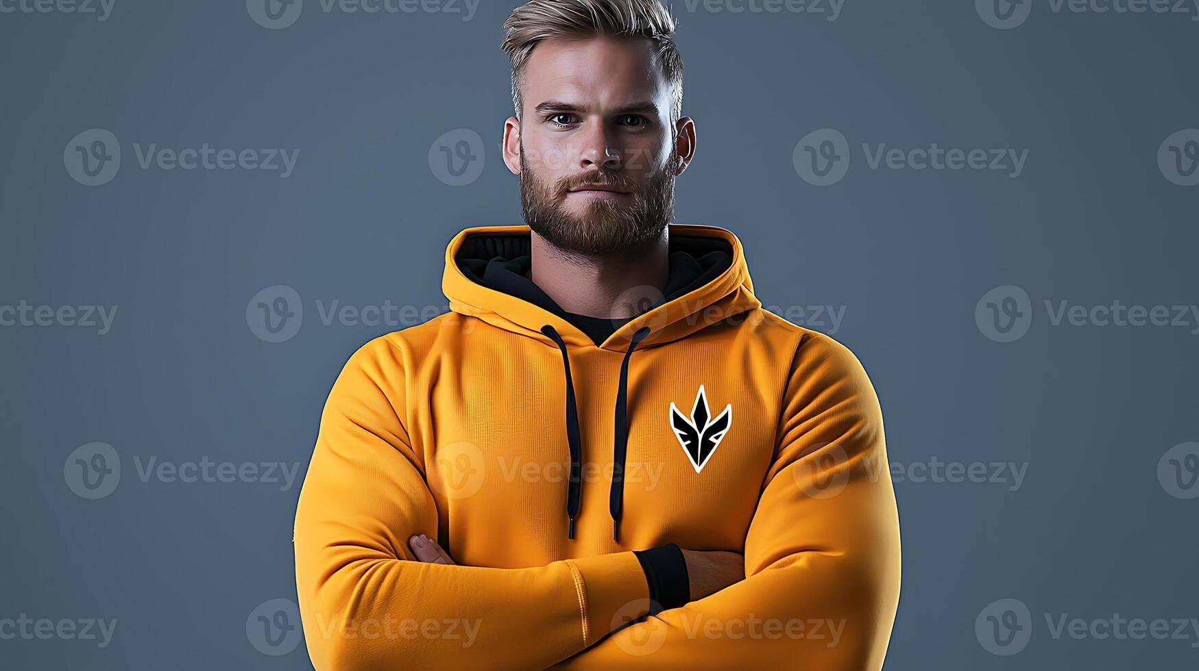 Confident man in a yellow hoodie posing against a gray background, showcasing athletic wear photo