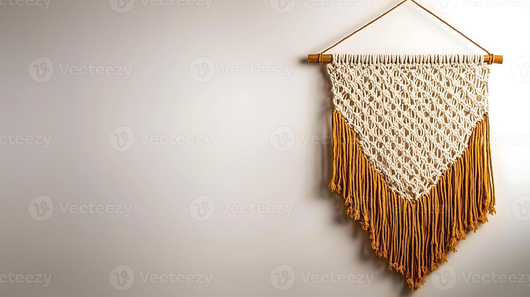 A beautifully crafted macram wall hanging with fringes, displayed on a neutral wall, enhancing decor photo