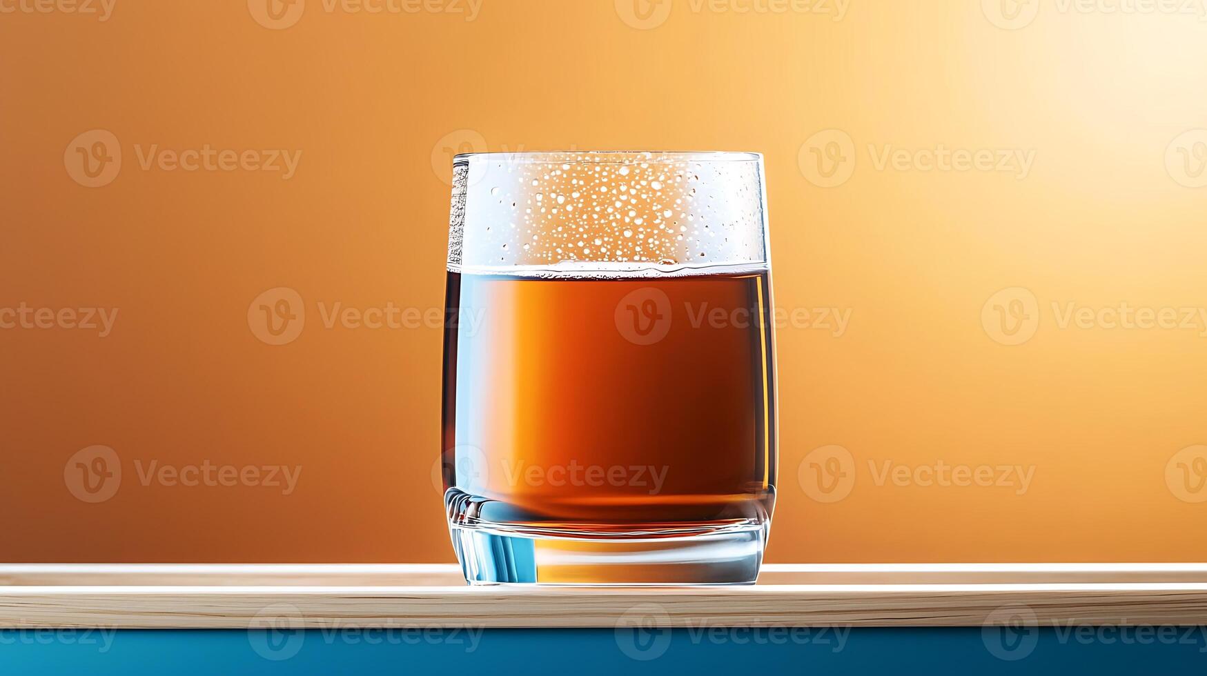 A close-up view of a glass filled with amber liquid on a wooden surface against a warm gradient background photo