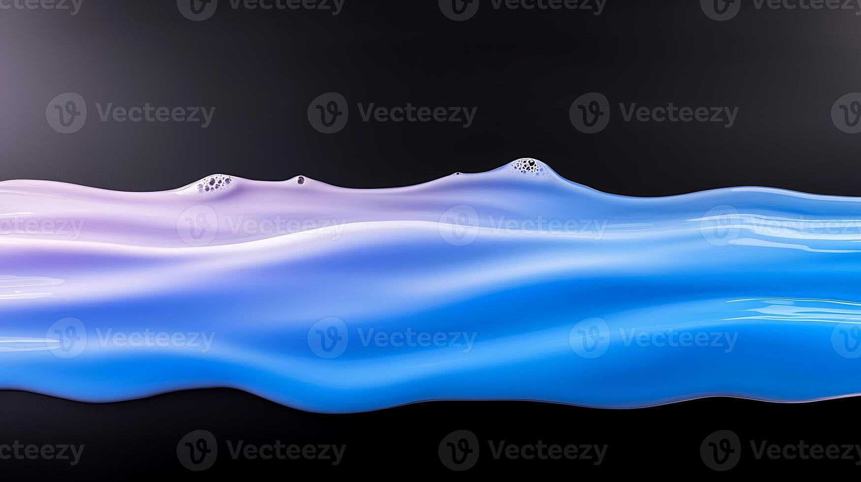 Fluid waves of blue and purple paint blend seamlessly on a dark background, creating an abstract art piece photo