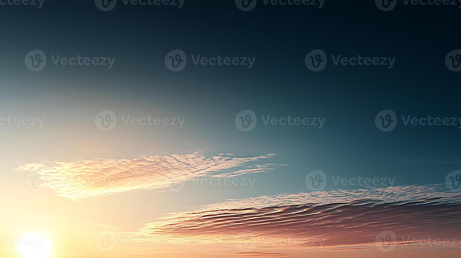 Serene sunset over a vast horizon with soft clouds reflecting warm colors in the sky photo