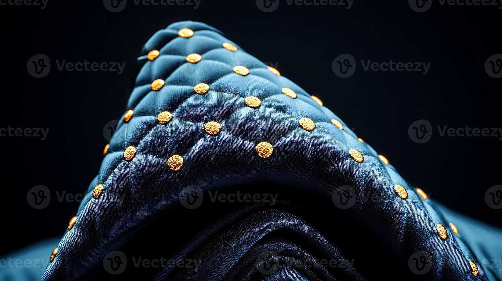 Close-up of a luxurious blue fabric with golden studs, showcasing intricate texture and design photo