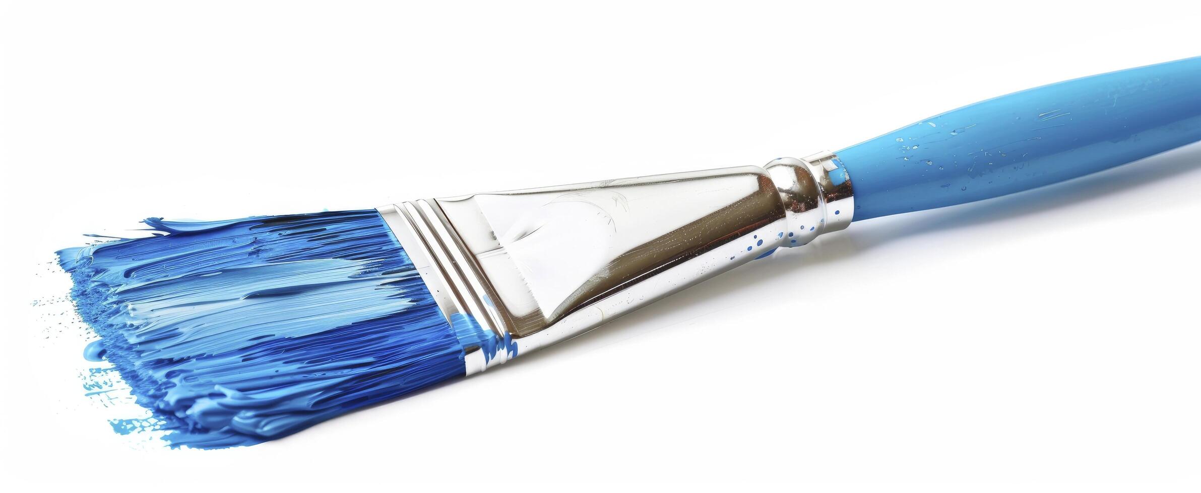 A paint brush with blue paint on it photo