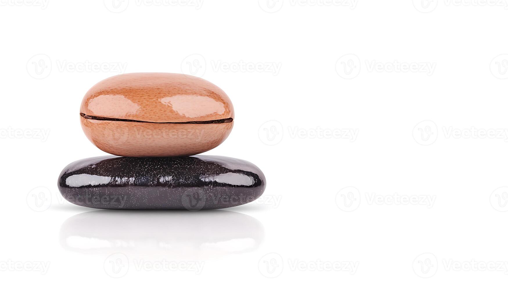 Two polished stones, one orange and one black, stacked on a white surface with a clean background photo