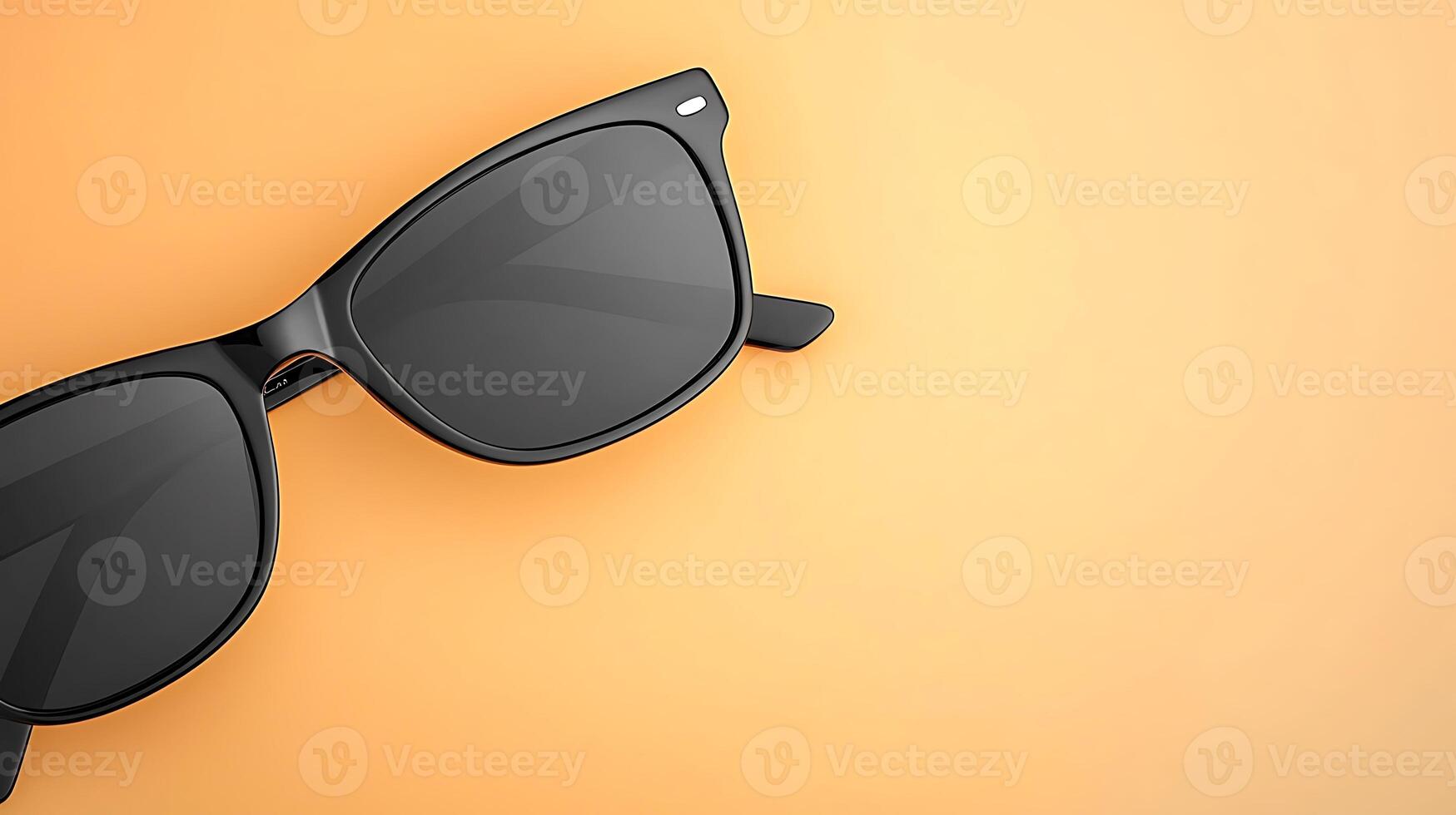Stylish black sunglasses resting on a vibrant orange background, perfect for summer fashion photo