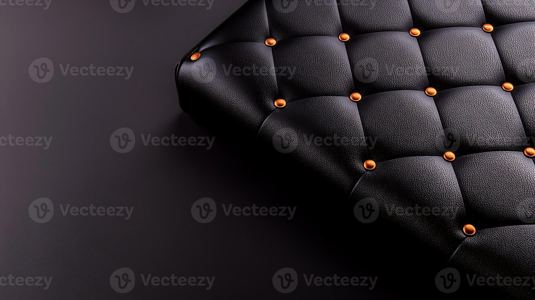 Close-up of a textured black leather surface with decorative golden buttons on a dark background photo