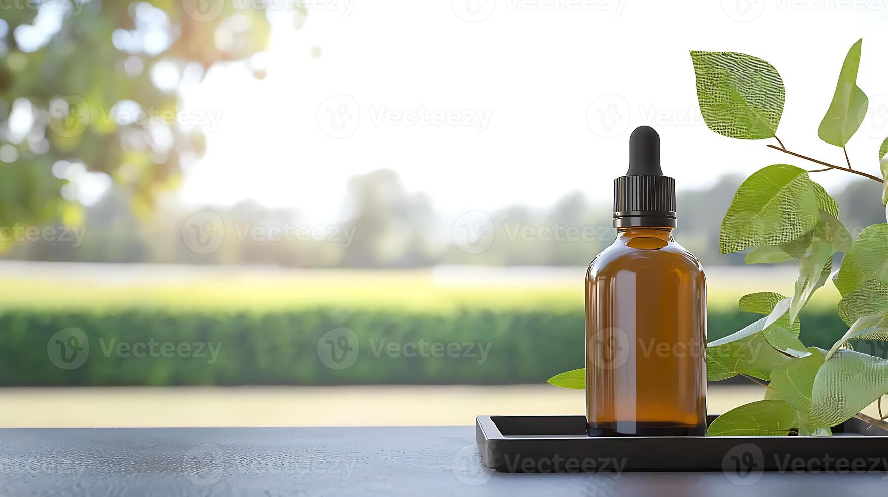 Amber glass dropper bottle placed on a tray with green leaves, set against a blurred nature background photo