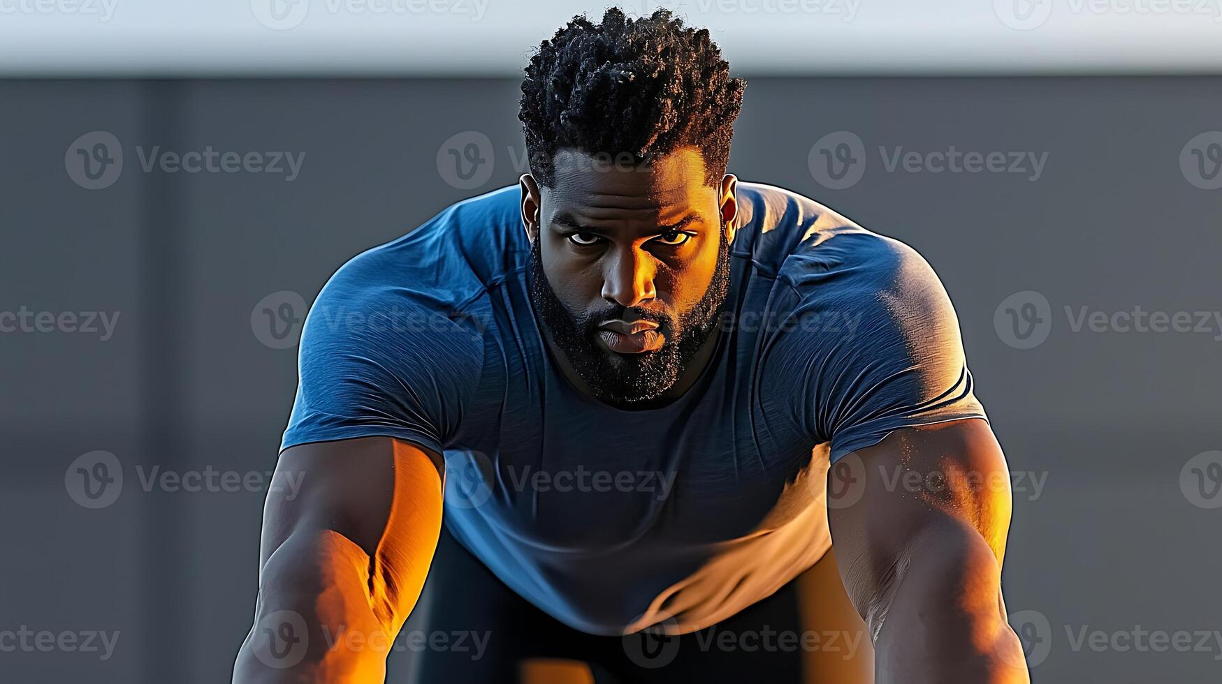 Athletic man preparing to sprint at sunset, showcasing determination and strength against a blurred urban backdrop photo